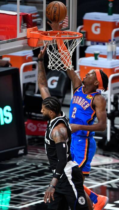 Guard Oklahoma City Thunder Shai Gilgeous-Alexander (2) mencetak angka melewati guard LA Clippers Paul George (13). REUTERS/Robert Hanashiro Guard Oklahoma City Thunder Shai Gilgeous-Alexander (2) mencetak angka melewati guard LA Clippers Paul George (13)