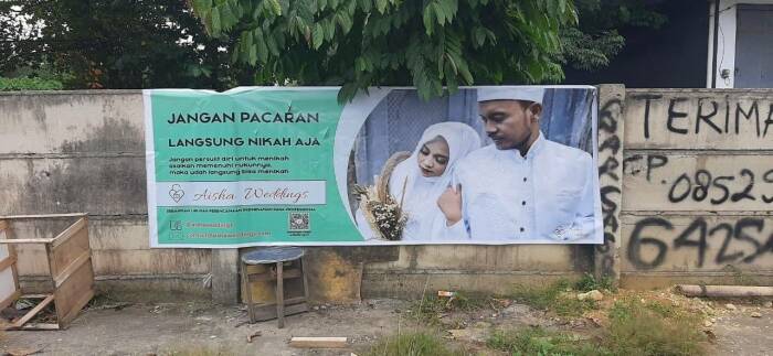 Spanduk Aisha Weddings di tembok. ist
